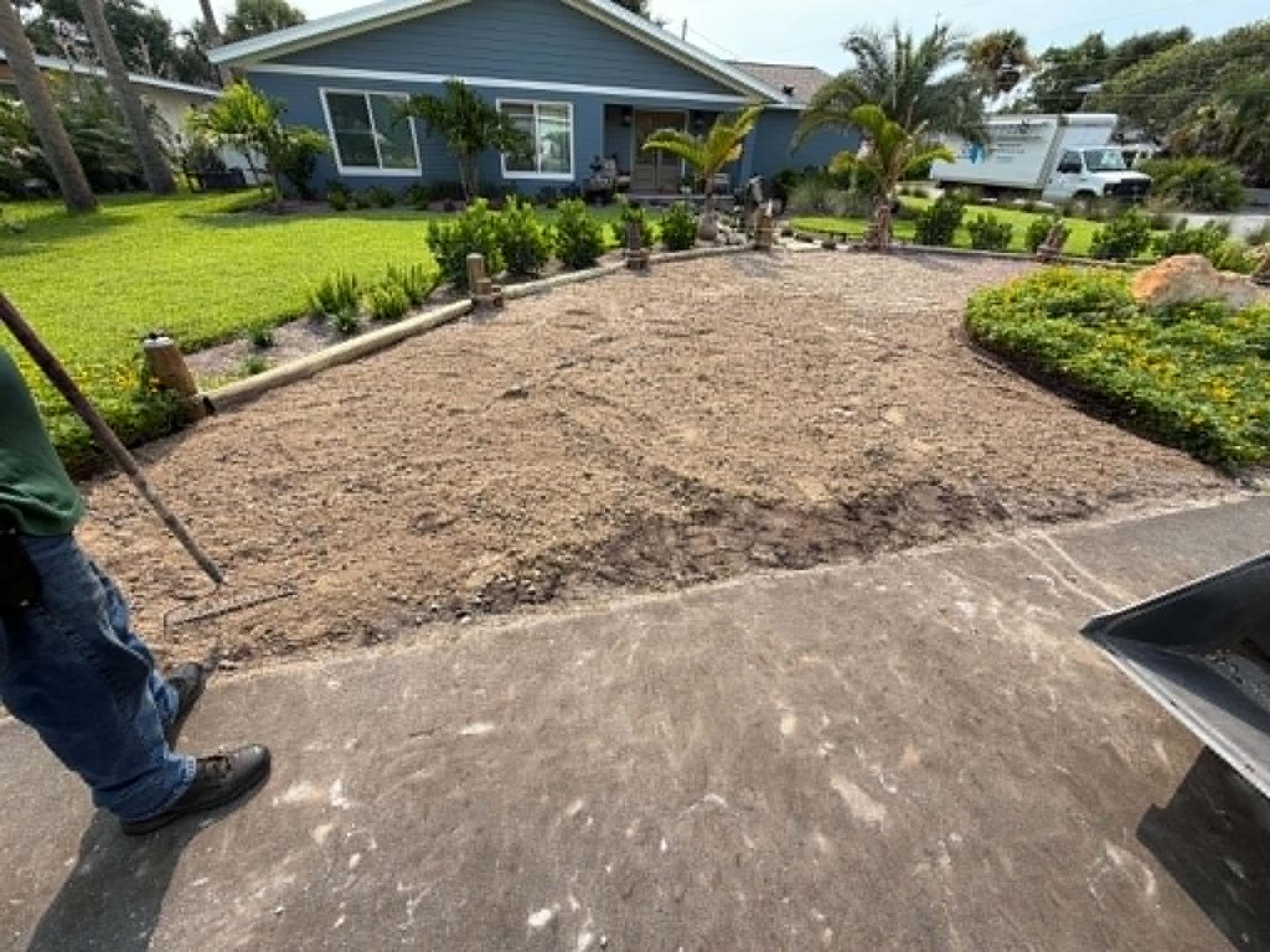 Trenching and base excavation along a driveway edge before installation